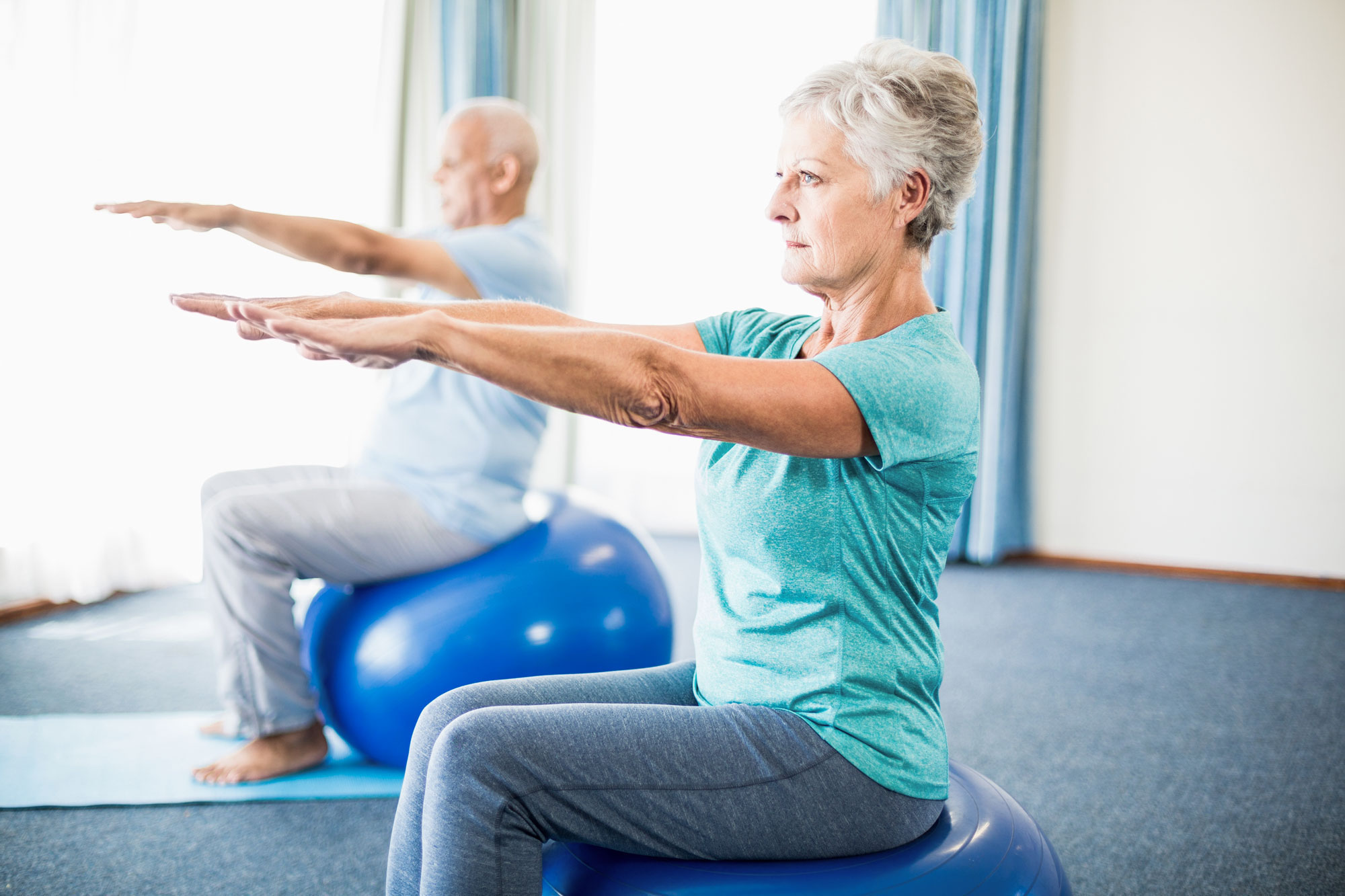 Seniors using exercise ball Seniors using exercise ball